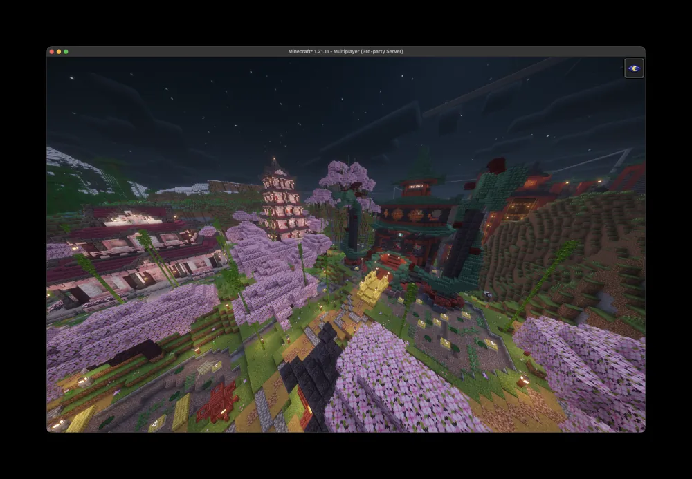 A cherry-blossom village built on the Paper server this toolkit runs on, lit up at night.